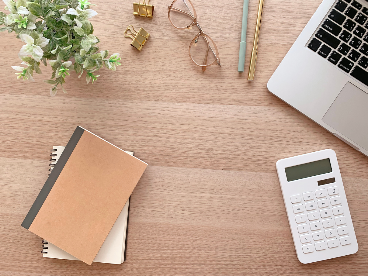 Wooden Desk with Laptop, Notebooks, Pens and Calculator